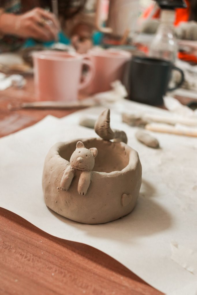 Artistic clay pottery featuring a cute animal design in a creative indoor workshop.